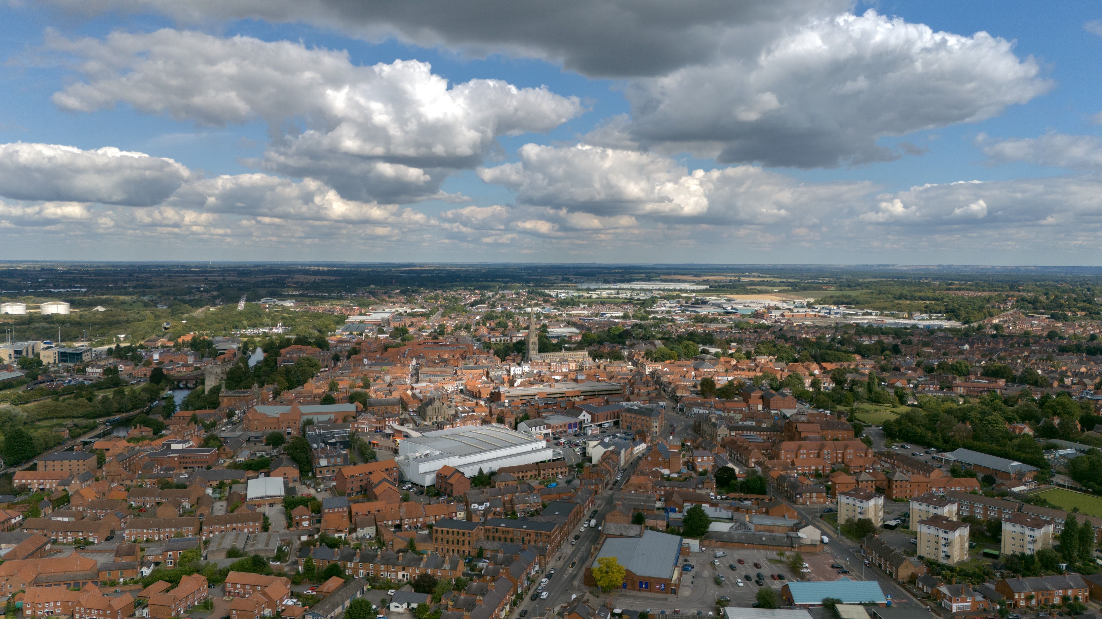 Wide aerial view across Newark-on-Trent beneath dramatic clouds